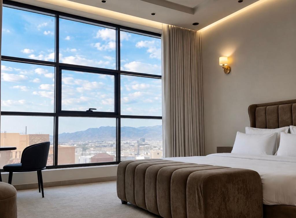 a hotel room with a bed and a large window at O2P Al Salam in Medina