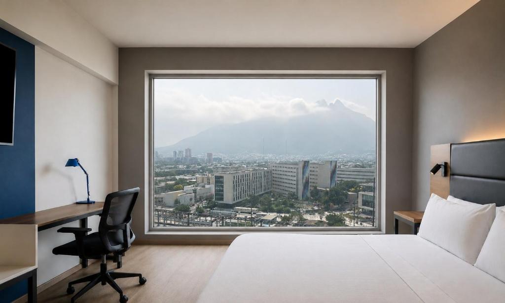 a hotel room with a large window with a view of the city at Fiesta Inn Monterrey Tecnologico in Monterrey