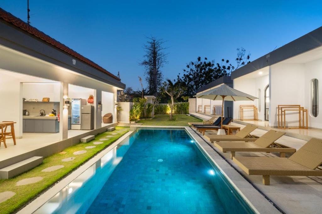 a swimming pool in the backyard of a house at Majestic Balangan in Uluwatu
