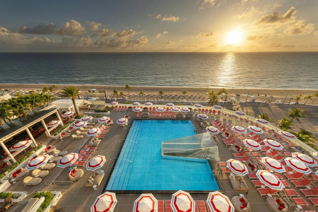 an aerial view of a resort with a swimming pool and the ocean at W Fort Lauderdale in Fort Lauderdale