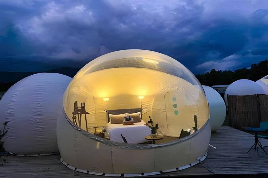 a large white domed room with a bed in it at Open Sky Bubble for sleeping under the stars in Valparaíso