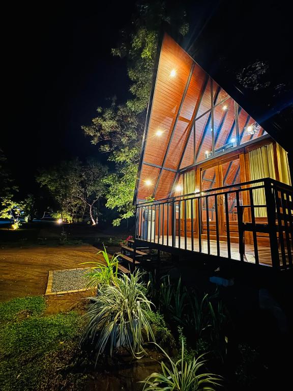 a building with lights on the side of it at night at Arcadiaa Cabana in Polonnaruwa