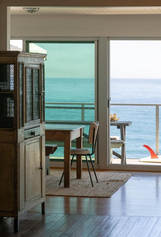a dining room with a table and a view of the ocean at Bay Properties Pacific Lodge in Yamba