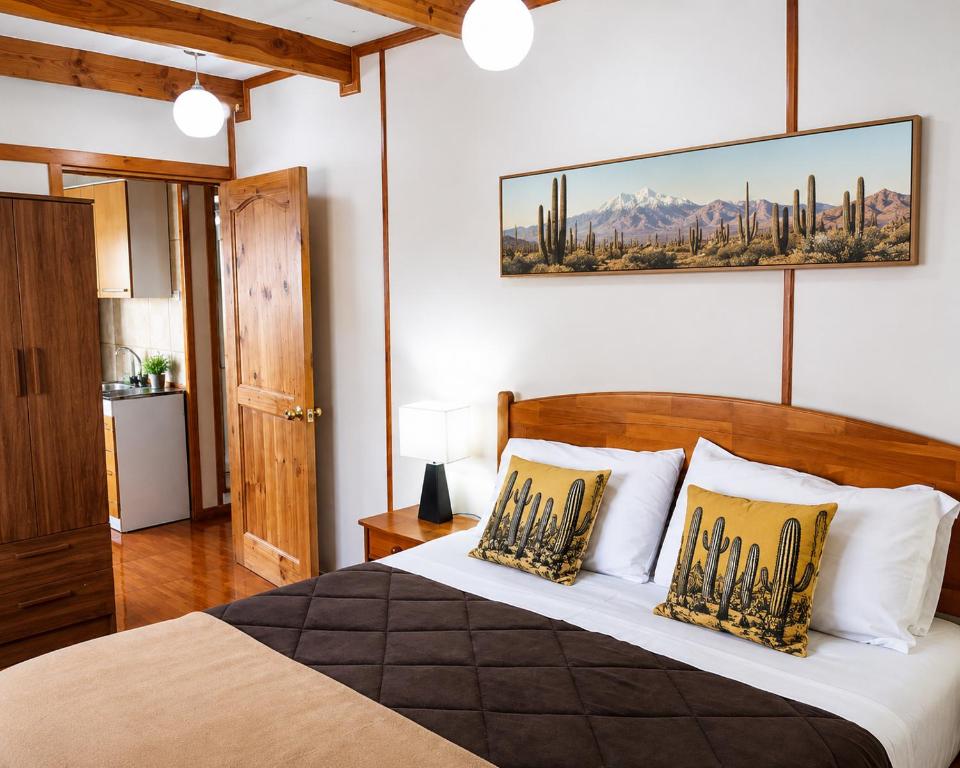 a bedroom with a large bed with two pillows at Apart Hotel Caldera - Room in Caldera