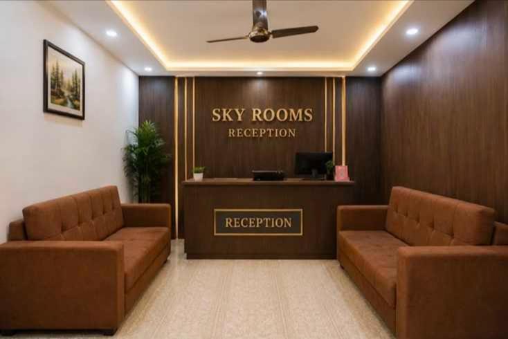 a hospital waiting room with two brown couches and a sign at Hotel O Sky Rooms in Jammu