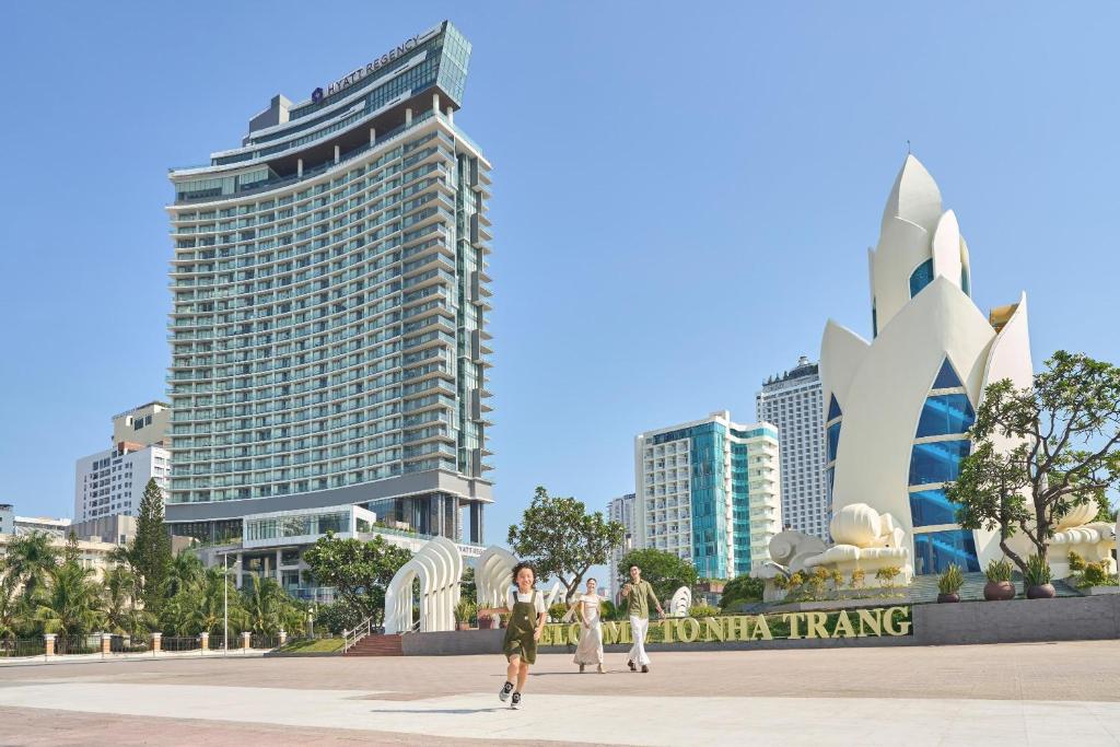a group of people walking in front of a city at Hyatt Regency Nha Trang in Nha Trang