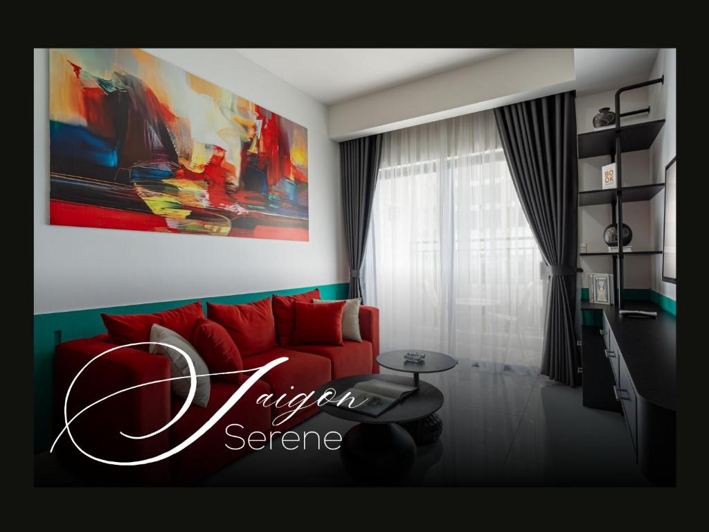 a living room with a red couch and a painting at Saigon Serene - SOHO Residence - Stay in District 1 in Ho Chi Minh City