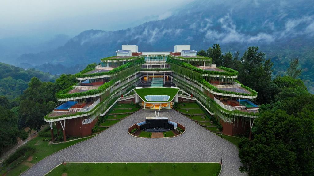 a building with plants on the side of it at Mountree Munnar by Kondody Hotels in Anachal