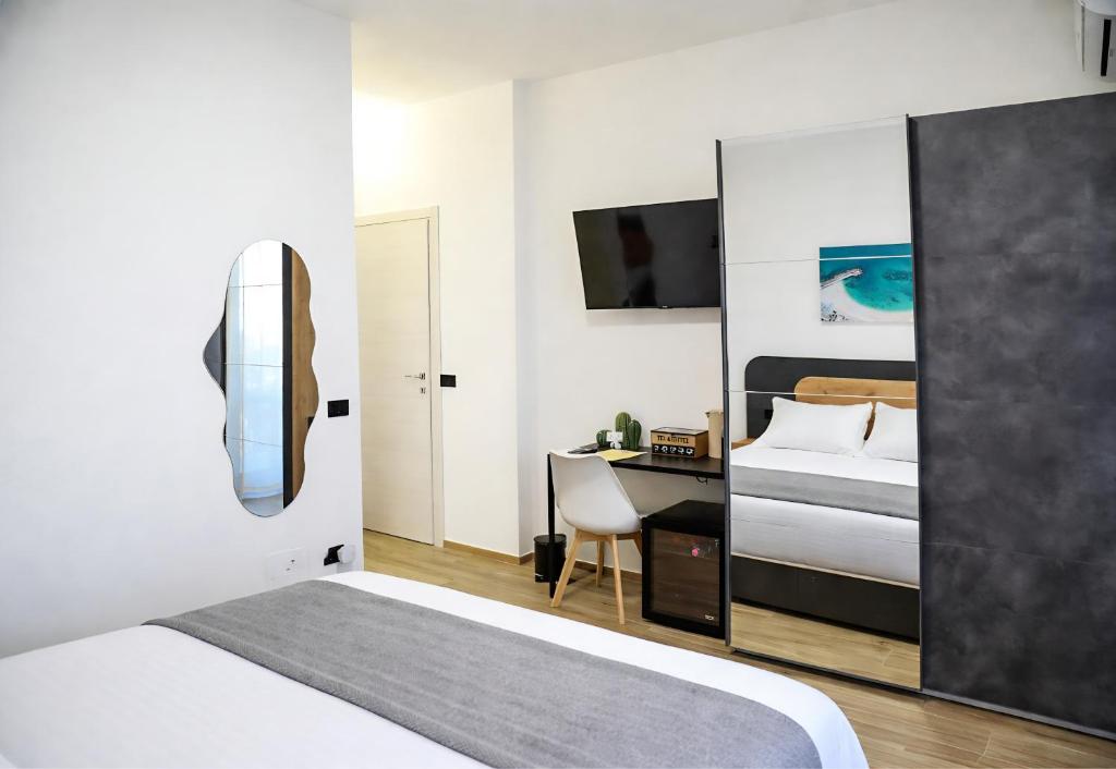 a bedroom with a bed and a desk with a computer at Affittacamere Brezza Di Sirolo in Sirolo