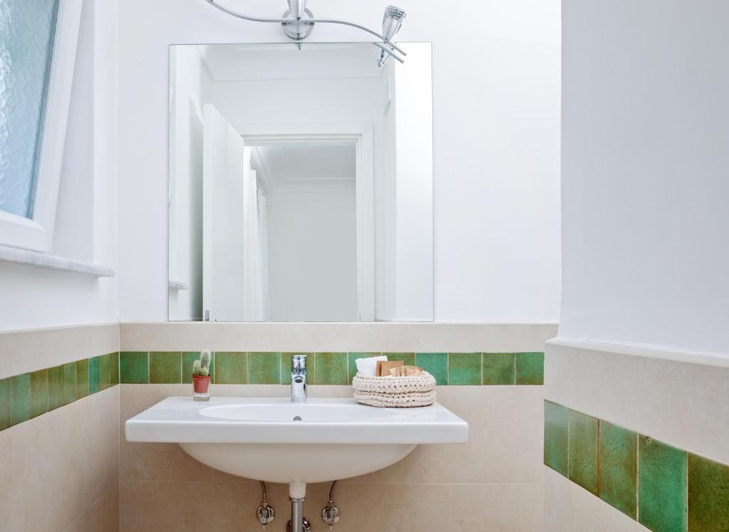 a bathroom with a sink and a mirror at Villa Pollio Guest House in Anacapri