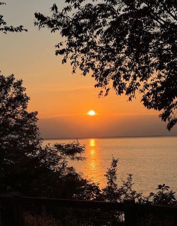 a sunset over the water with the sun setting at Yiganda Hotel, Ethiopia in Bahir Dar