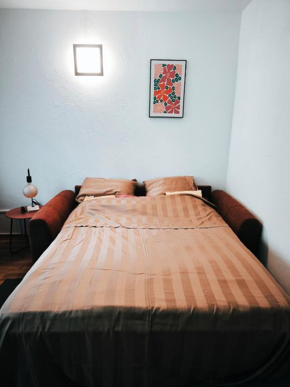 a bed in a bedroom with a blanket on it at Turckheim in Turckheim