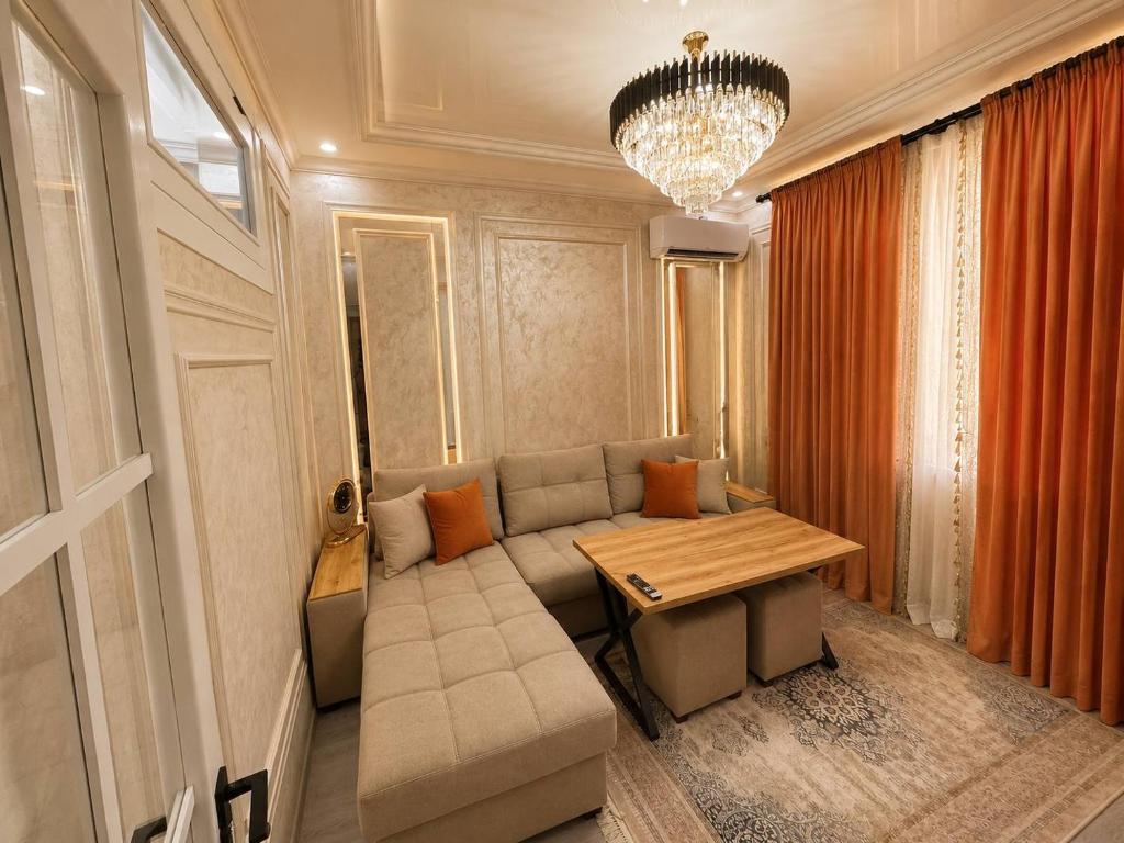 a living room with a couch and a table at Luxanda Plaza in Samarkand