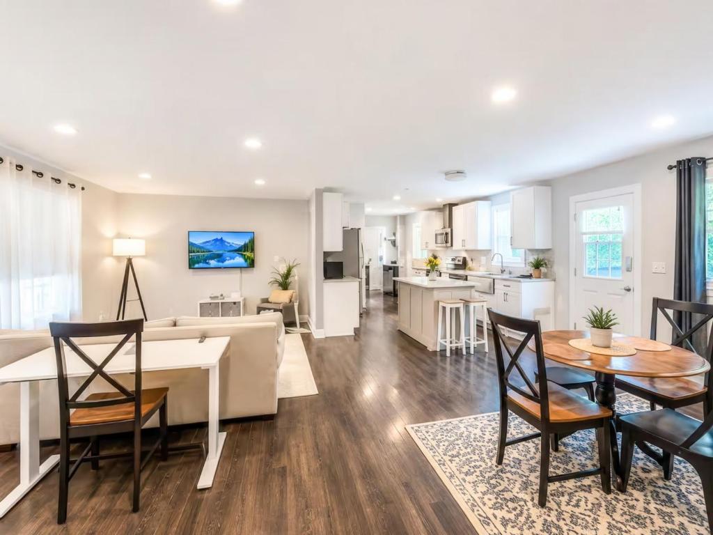 a living room and kitchen with a table and chairs at Tucked away in Tucker in Tucker