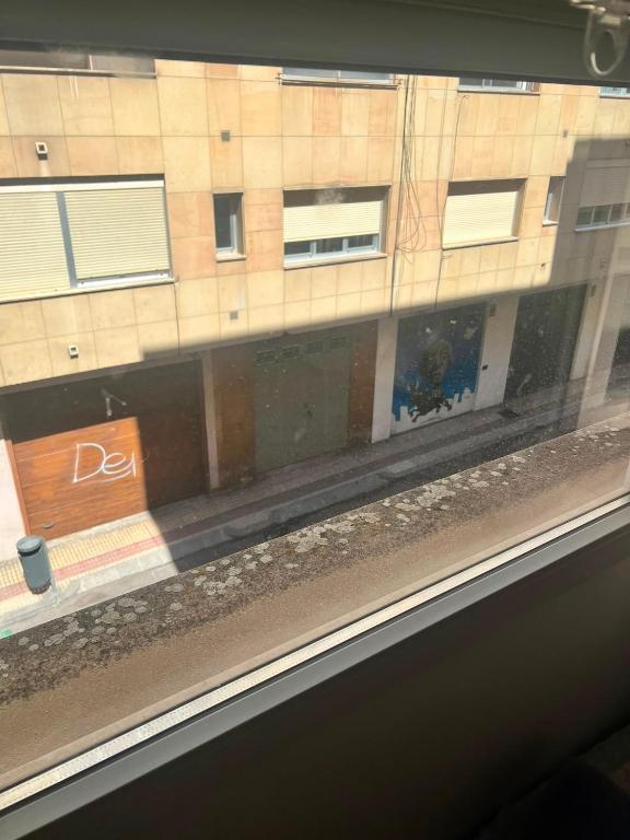 a view of a building from a train window at Steve's Condo in Davao City