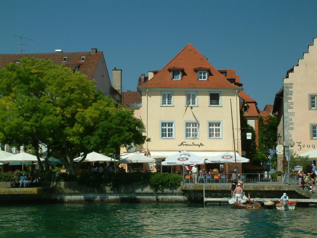 a group of people sitting on a boat in the water at Hotel Strandcafé Dischinger in Überlingen