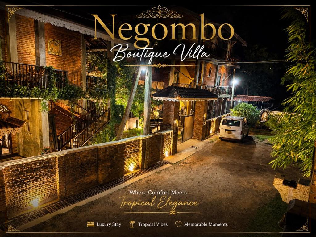 a sign that reads neogno boutique village at night at Negombo Boutique Villa in Negombo