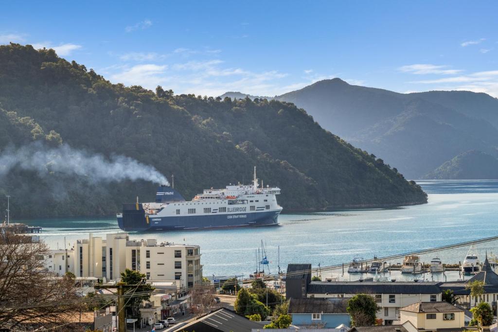 a large boat in the water near a city at Sea-Renity Picton, Apt B in Picton