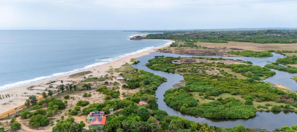 an aerial view of a beach and a river at Kudakalliya Beach Houses in Arugam Bay