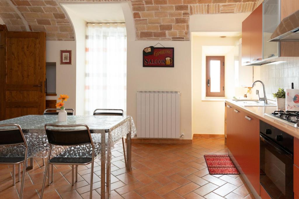 a kitchen with a table and chairs in a room at La Rusacca Pacentro in Pacentro