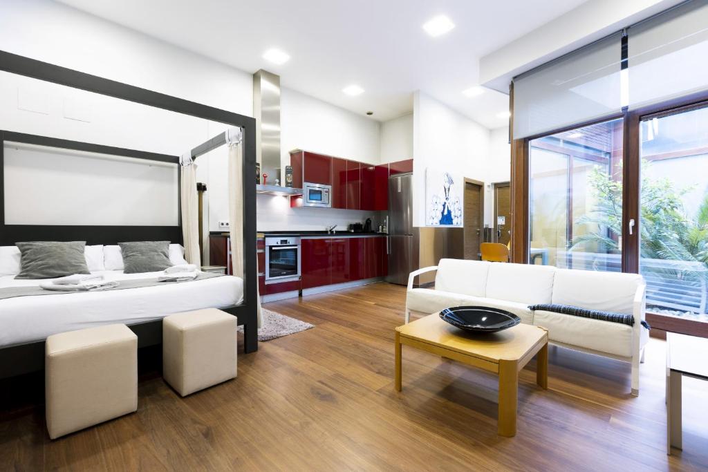 a bedroom with a bed and a living room at Loft by Basquelidays in Hondarribia