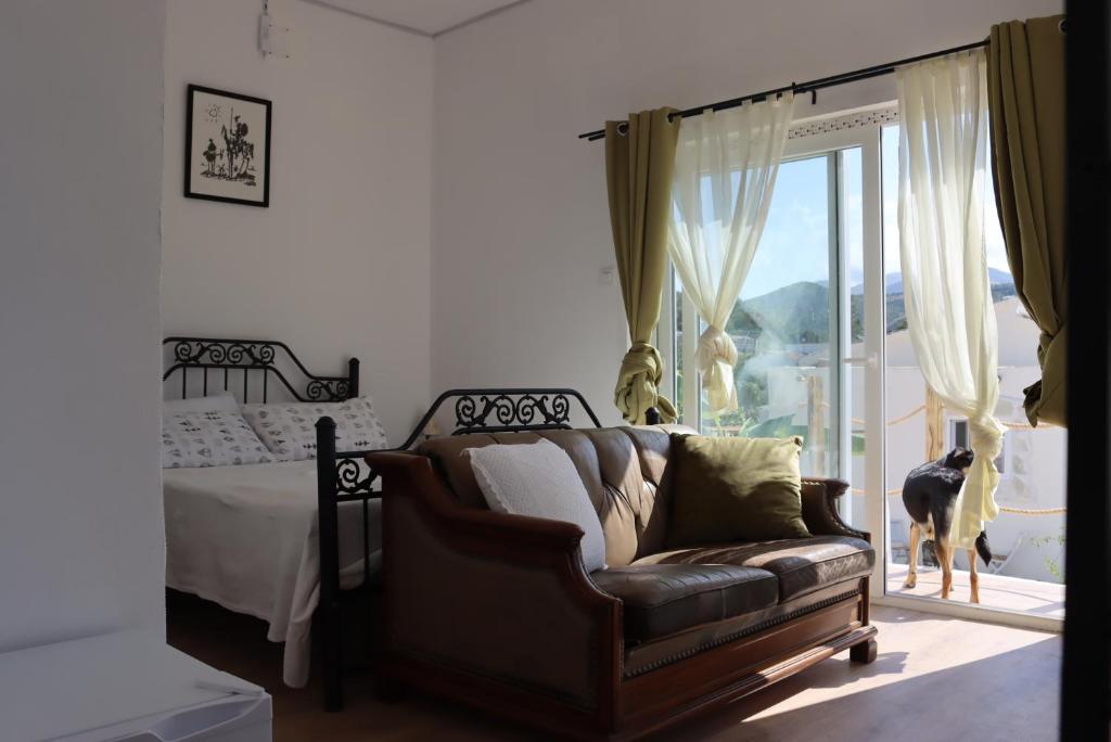 a bedroom with a couch and a bed and a window at CocoHills in Monte Pego