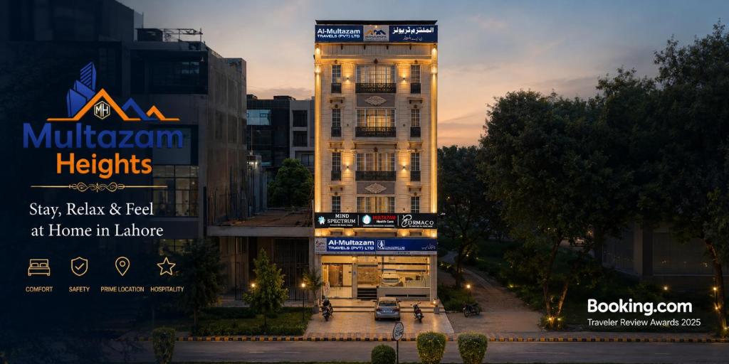 a tall building with a sign in front of it at Multazam Heights, DHA Phase 8, Hotel Airport Lahore in Lahore