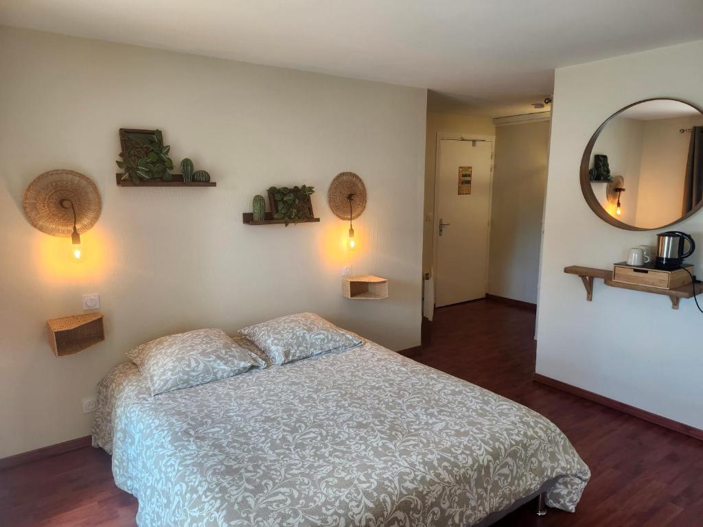 a bedroom with a bed and a large mirror at Douglas in Colleville-sur-Mer