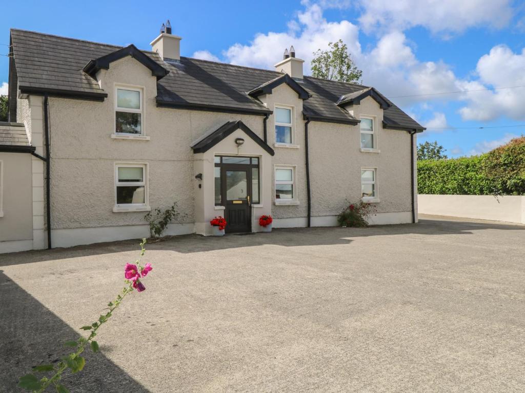 a large house with a driveway in front of it at Greenfield House in Aghavas