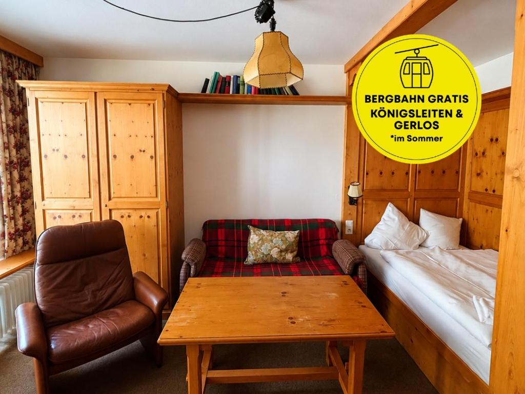 a room with a bed and a table and a chair at Haus Stöckl Top 14 in Königsleiten