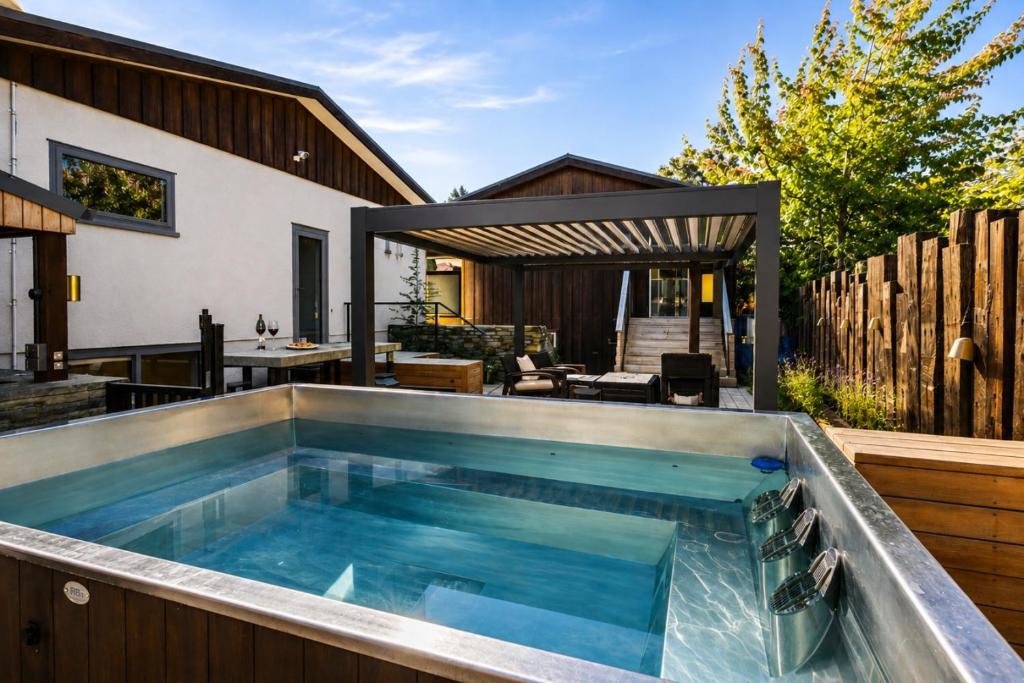 a swimming pool on a patio with a house at Alp Studios Apartment 2 in Wanaka