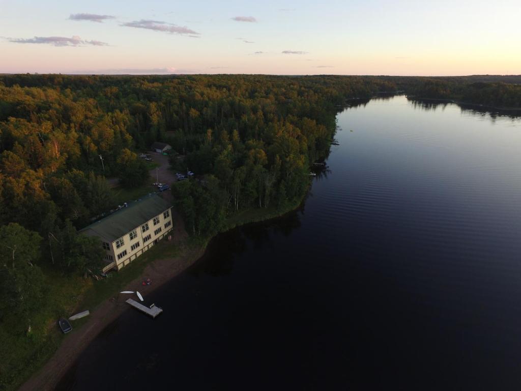 an aerial view of a building on the shore of a lake at Hanging Horn Lakeside Resort in Moose Lake