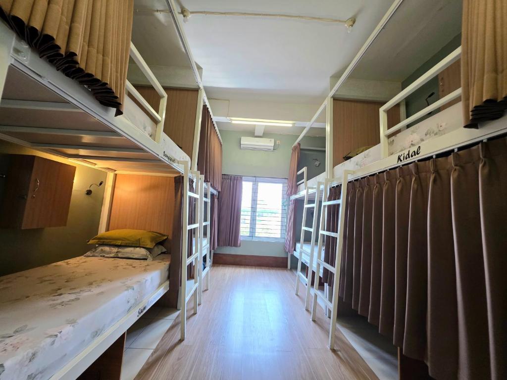 a room with two bunk beds and a hallway at Little Malang Hostel小玛瑯青年旅舍 in Malang