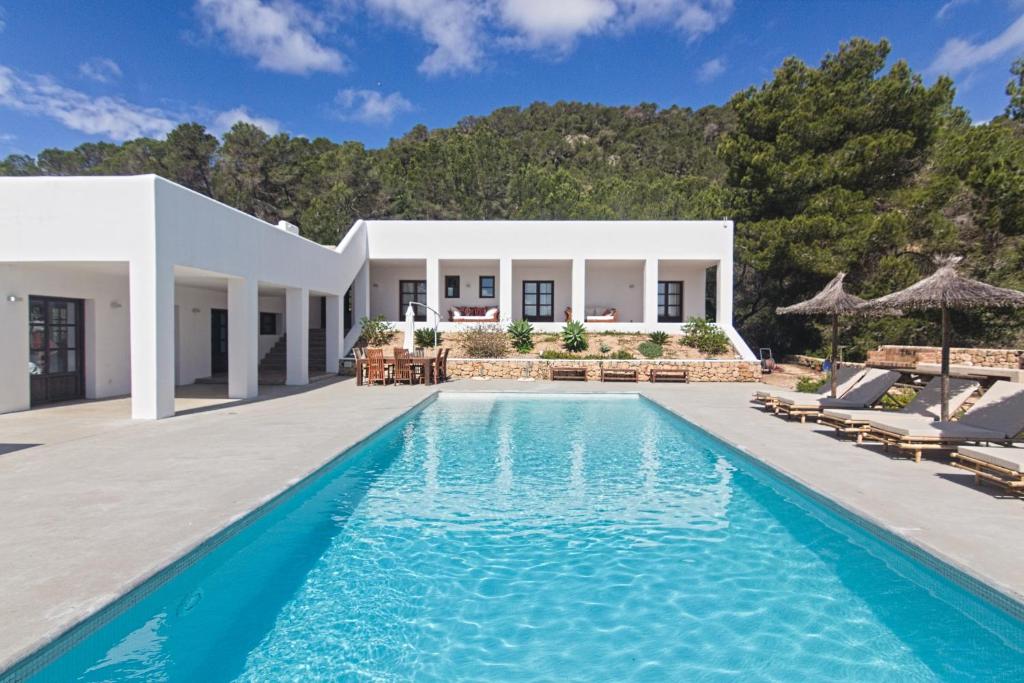 a villa with a swimming pool and a house at Villa Arenas in Sant Josep de sa Talaia