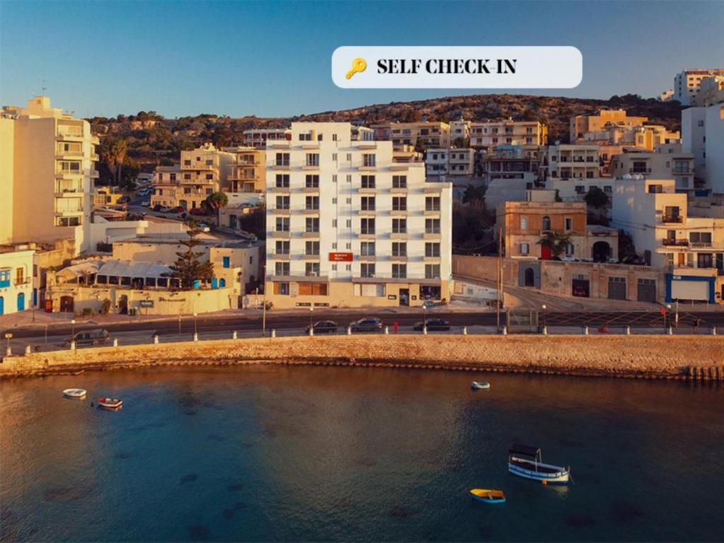 a view of a city with boats in the water at Seaview Stays in St. Paul's Bay