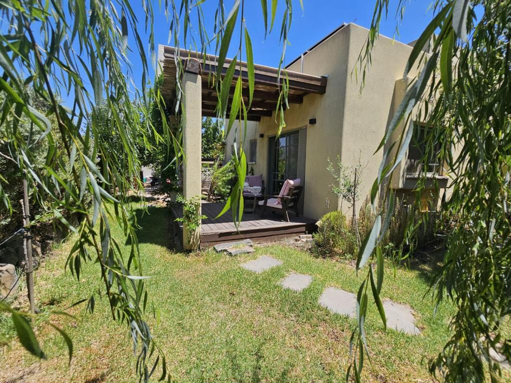 a house with a table and a chair on a porch at Ido and Racheli in Yonatan