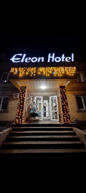 a sign for a hotel with stairs in front at Eleon in Almaty