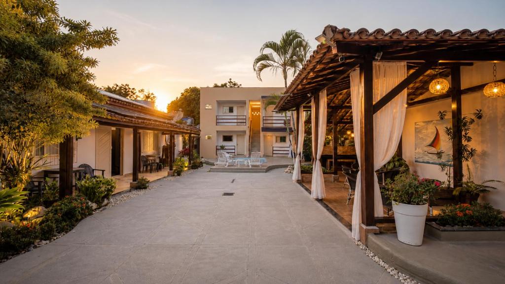 a courtyard of a house with a patio at Villa Sunset in Arraial d'Ajuda