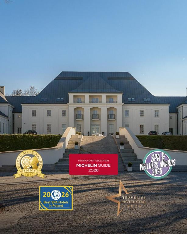 a building with a sign in front of it at Zamek Janów Podlaski in Janów Podlaski