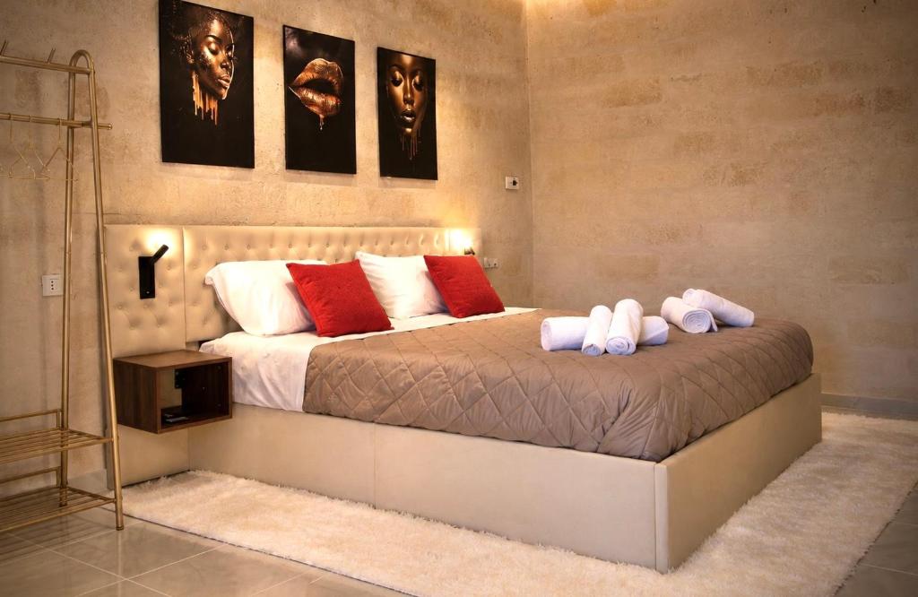 a bedroom with a large bed with red and white pillows at Aphrodeseum Romantic Suite in Taranto