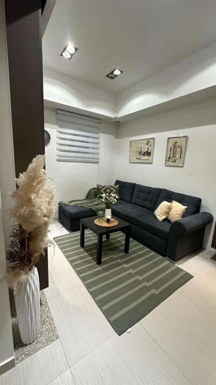 a living room with a blue couch and a table at TIM Apartment Sarajevo with private parking in Sarajevo