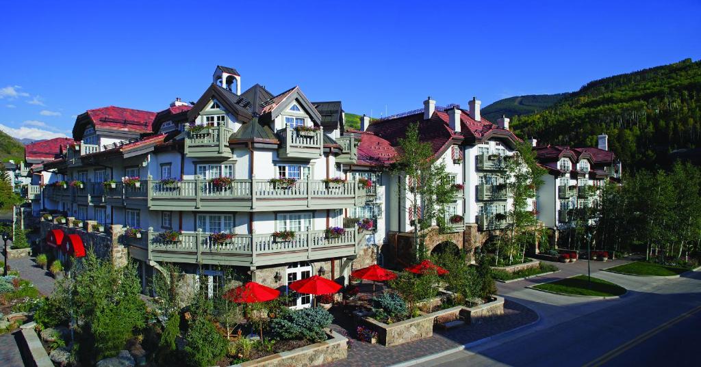 a large building with red umbrellas in front of it at Sonnenalp in Vail