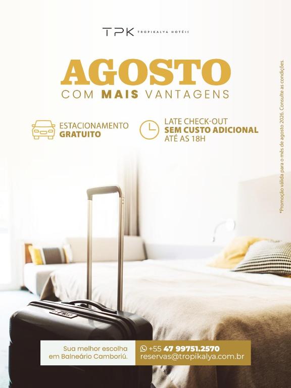 a magazine advertisement for acosco tom mas variances with a bed and suitcase at Tropikalya Prime Hotel in Balneário Camboriú