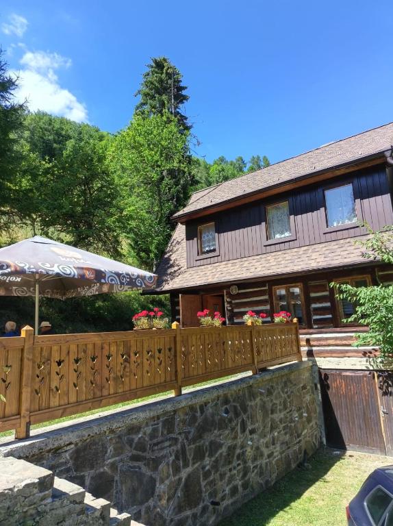 a wooden fence in front of a house at Chalupa SKI Jezersko in Vígľaš