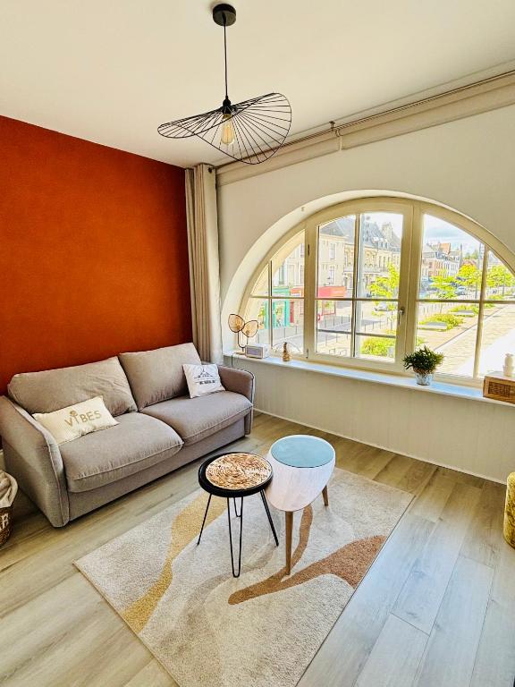 a living room with a couch and a table at La Scène Audomaroise - Appartement hyper centre in Saint-Omer