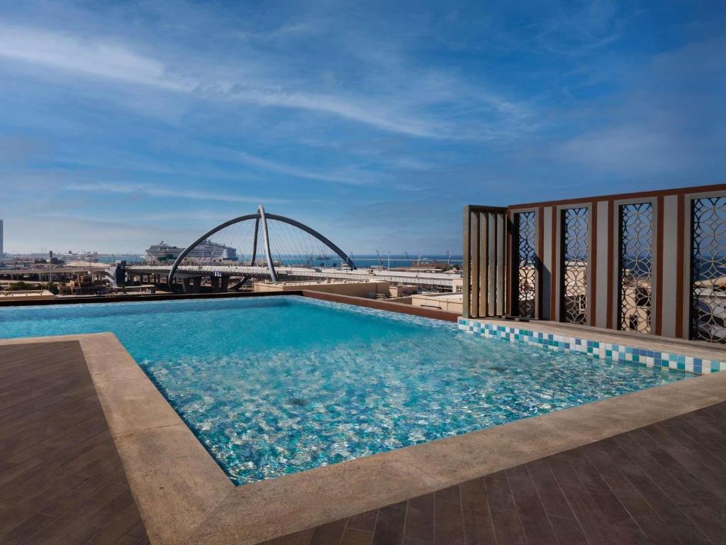 a swimming pool on the roof of a building at ibis Styles Dubai Deira in Dubai