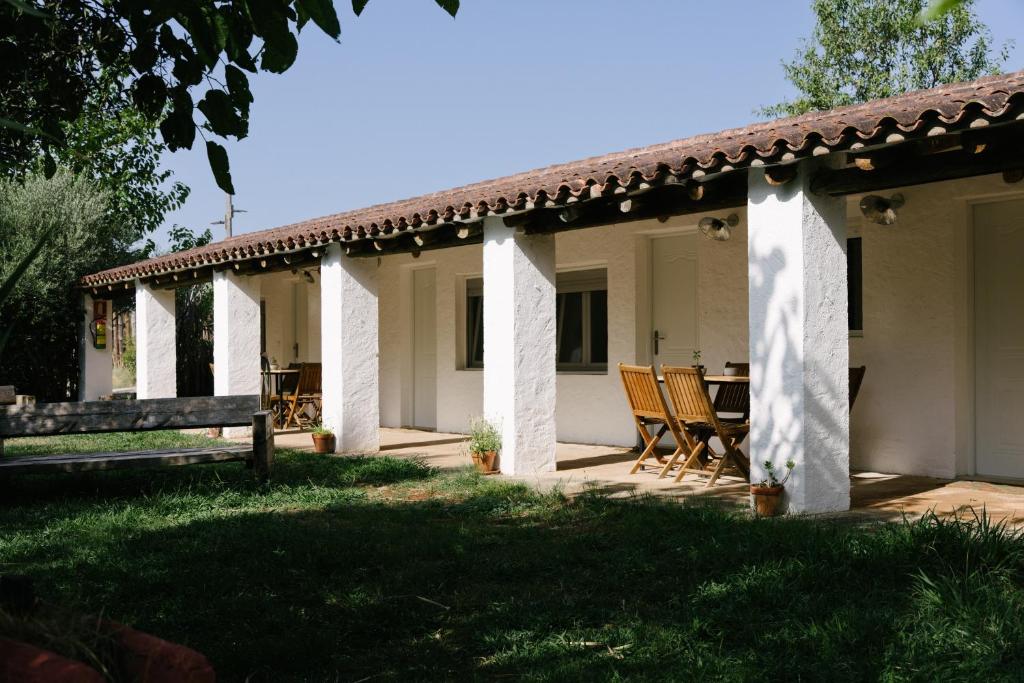 a patio of a house with chairs and a table at Camping Armalygal in Murillo de Gállego