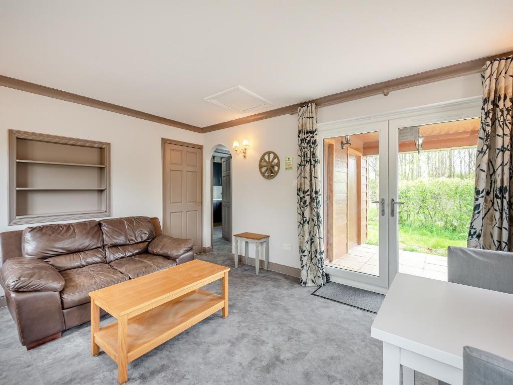a living room with a couch and a table at Teal - Uk41036 in Marston