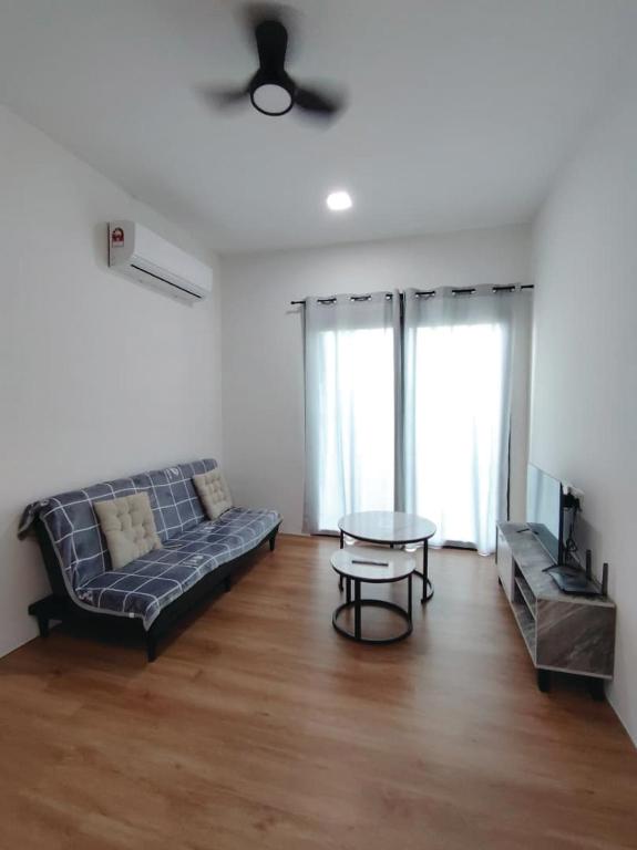 a living room with a couch and a table at Hann's Avenue Suites - Heart of Sibu - Free Parking in Sibu