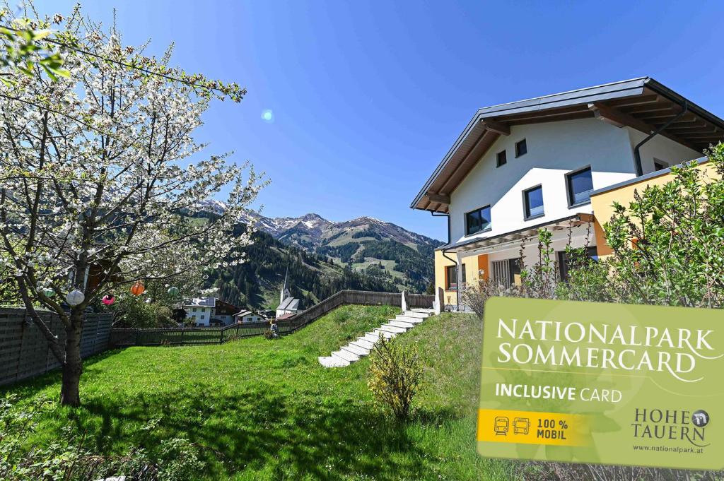 a house with a sign in front of a yard at Chalet Creatina by we rent, NATIONALPARK CARD INCLUDED in Rauris
